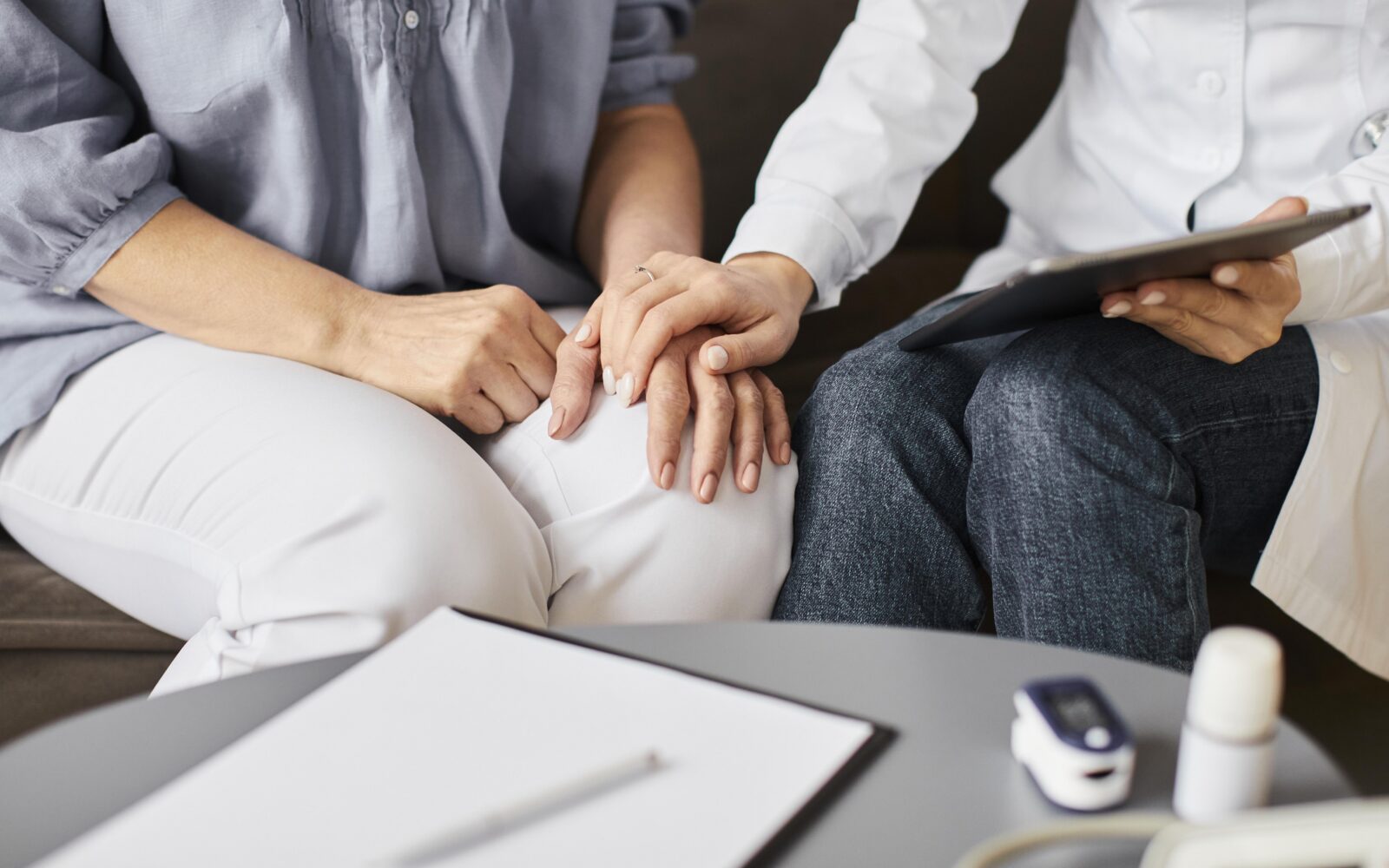 covid-recovery-center-female-doctor-checking-health-results-with-older-patient