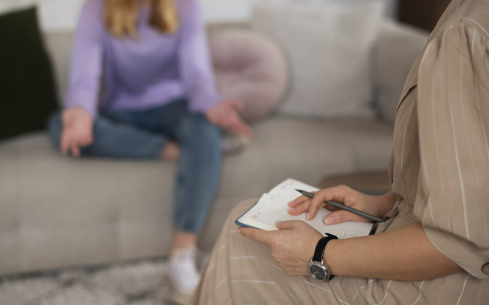 side-view-young-girl-talking-therapist